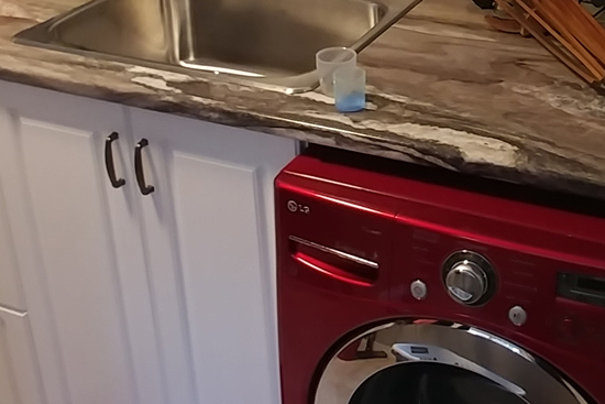 Laminated countertop with white foil door cabinets